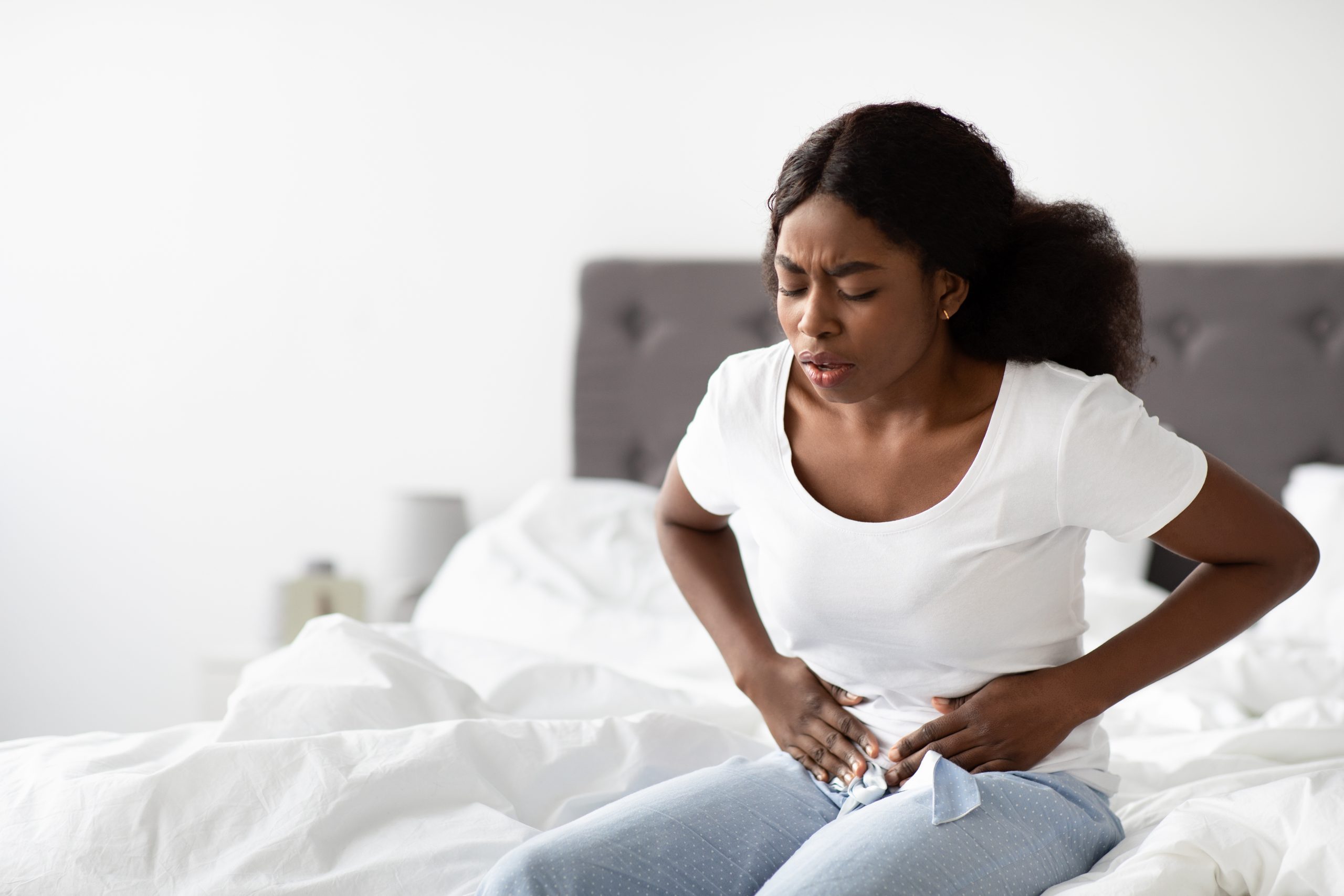 young-black-woman-suffering-from-abdomen-pain-in-the-morning
